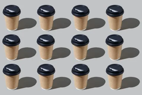 Colourful pattern of disposable paper cups on grey background. View from top. Stock Photos