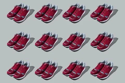 Colourful pattern of sneakers on grey background. View from top. Stock Photos