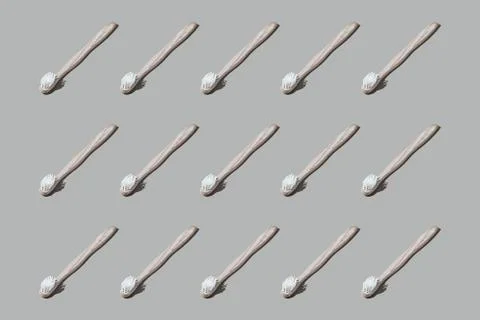 Colourful pattern of toothbrushes on grey background. View from top. Stock Photos