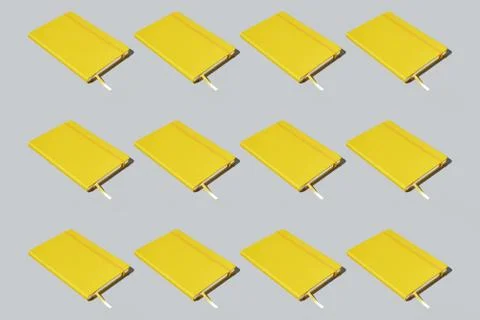 Colourful pattern of yellow notebooks on grey background. View from top. Stock Photos