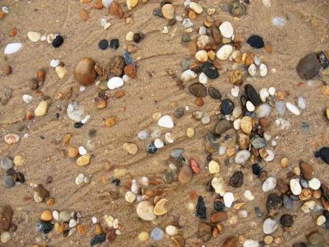 Colourful pebbles in the sand Stock Photos