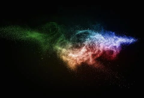 Colourful powder exploding isolated on black 写真素材