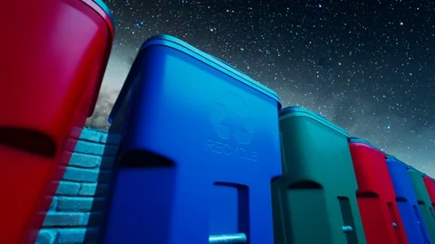Colourful recycle trash bins against the stary night sky. Ecology. Eco-house. Stock Footage
