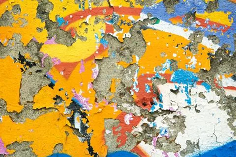 Colourful remnants of peeling graffiti Stock Photos
