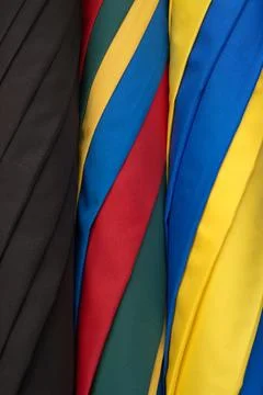 Colourful rolled umbrellas for use as a background texture Stock Photos