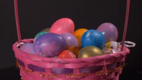 Colourful Rotating Basket With Easter Eggs on Black Background, Easter Video stock 129065131