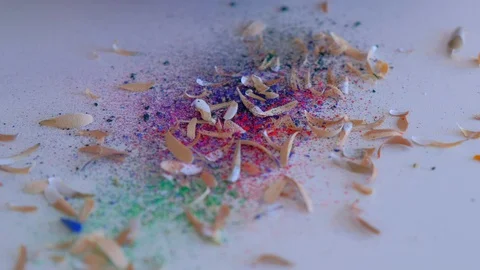 Colourful shavings on white table, sharpening pencil sharp knife, hands closeup. Stock Footage 128750419