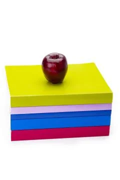 Colourful stack of books with apple on top Stock Photos