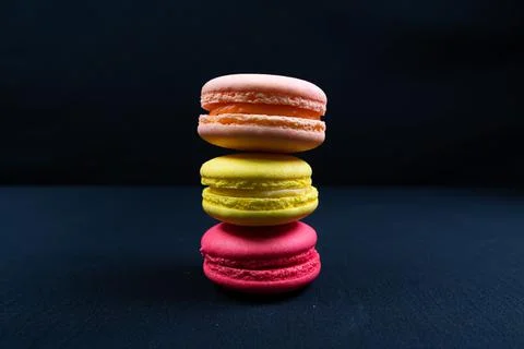 Colourful stack of macaroons isolated on plain black background. Copyspace Stock Photos