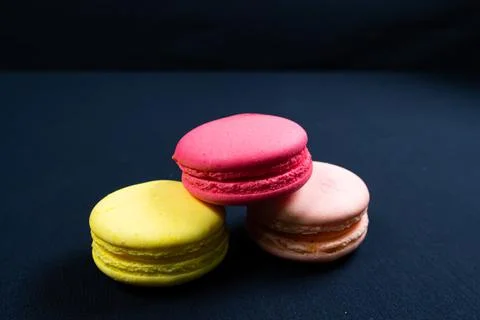 Colourful stack of macaroons isolated on plain black background. Copyspace Stock Photos
