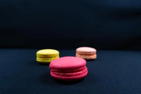 Colourful stack of macaroons isolated on plain black background. Copyspace Stock Photos