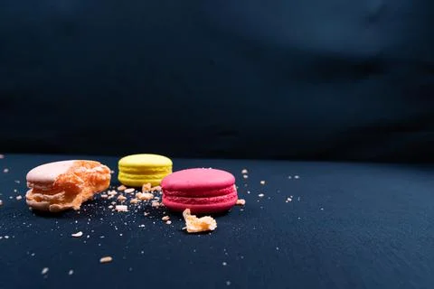 Colourful stack of macaroons isolated on plain black background. Copyspace Stock Photos