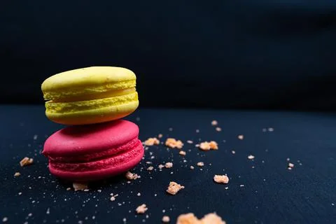 Colourful stack of macaroons isolated on plain black background. Copyspace Stock Photos