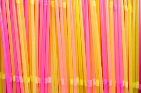 Colourful straws arranged vertically side by side. Stock Photos