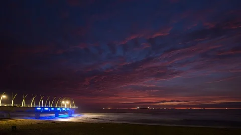 A colourful sunrise timelapse looking towards the Umhlanga pier in Durban, Stock Footage 92209779