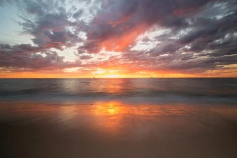 Colourful sunset with clouds at the beach Stock Photos
