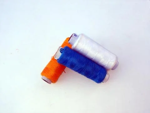 Colourful thread spools isolated on a white Stock Photos