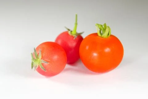 Colourful tomatoes on a table Stock Photos