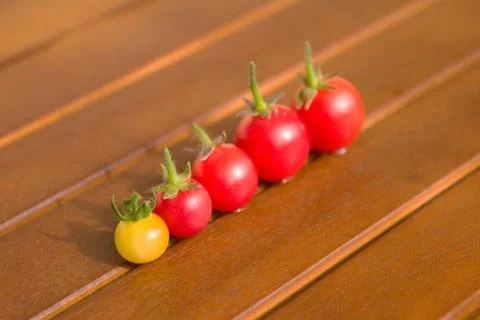 Colourful tomatoes on a table Stock Photos