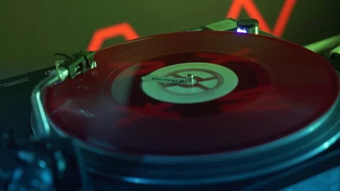 The colourful vinyl record is spinning on the controller Stock Footage 122153591