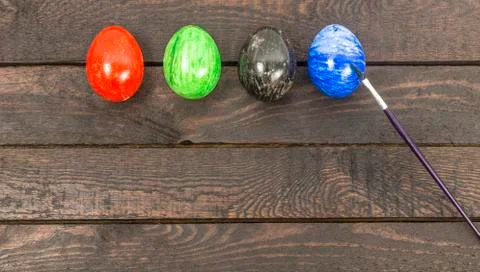Colouring eggs with brush for eastertime at home Stock Photos