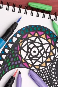 Colouring a mandala Stock Photos