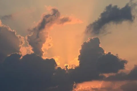 The colours of sunrise seen through clouds. Stock Photos