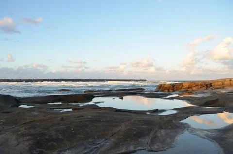 The colours of sunset reflected in rockpools. Stock Photos