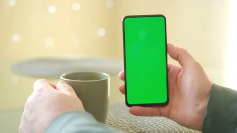 Colse-up of man hands using green screen smartphone and enjoy drinking afternoon Stock Footage 235458555
