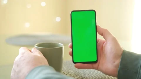 Colse-up of man hands using green screen smartphone and enjoy drinking afternoon Stock Footage 236456232