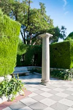 Column and garden. Stock Photos