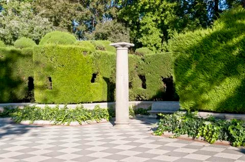 Column and garden. Stock Photos