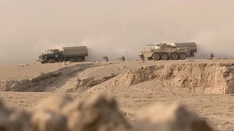 The column of armored vehicles in a combat zone in the desert, the attack Stock Footage 145840226