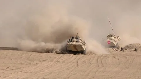 A column of armored vehicles passes through a checkpoint to perform Stock Footage 145840506