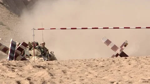 A column of armored vehicles passes through a checkpoint to perform a combat Video stock 145840648