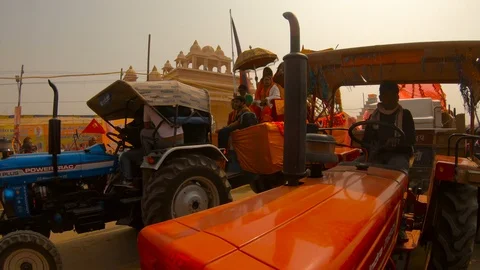 Column of decorated tractors with representatives of untouchable cast police gua Stock Footage 106836631