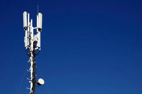 Column of mobile communication against the background of the blue sky Stock Photos