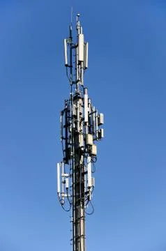 Column of mobile communication against the background of the blue sky Stock Photos
