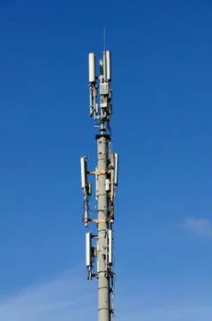Column of mobile communication against the background of the blue sky Stock Photos