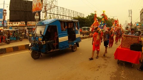 Column of pilgrims carry ritual decorated with flowers and flags of India contai Stock Footage 119516614