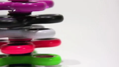 A column of several spinners revolves on a white background. Video stock 77738330