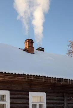 Column of smoke rises from the chimney Stock Photos