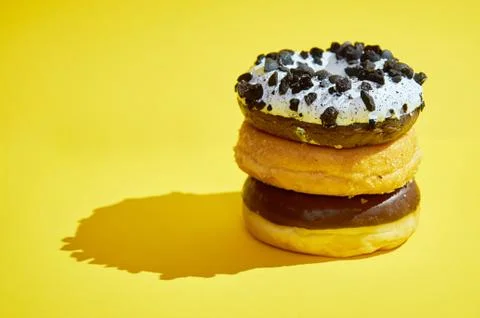 A column of three donations on a yellow background. Shadows. Stock Photos