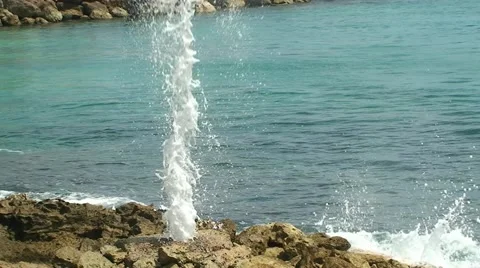 Column of water from the rocks hole on the ocean wave Stock Footage 53781472