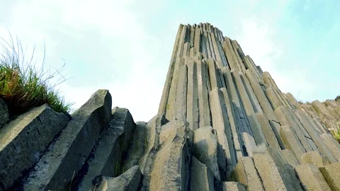A columnar basalt rock and the bright blue sky Stock Footage 72545328