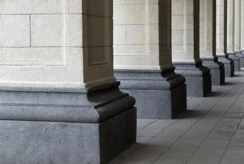 The columns of the building are lined up. Close-up . urban architecture Stock Photos