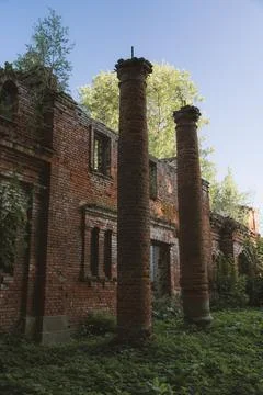 The columns of the destroyed red brick stable. 19th century buildings. Stock Photos