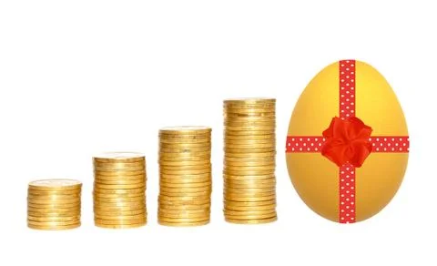 Columns of gold coins and easter egg with red ribbon over white background Stock Photos