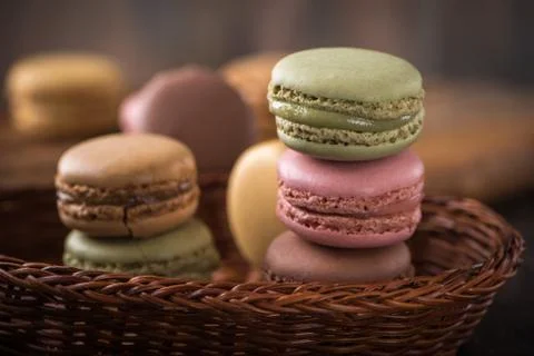 Columns with macaroons on wicker basket background Stock Photos