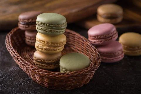 Columns with macaroons on wicker basket background Stock Photos